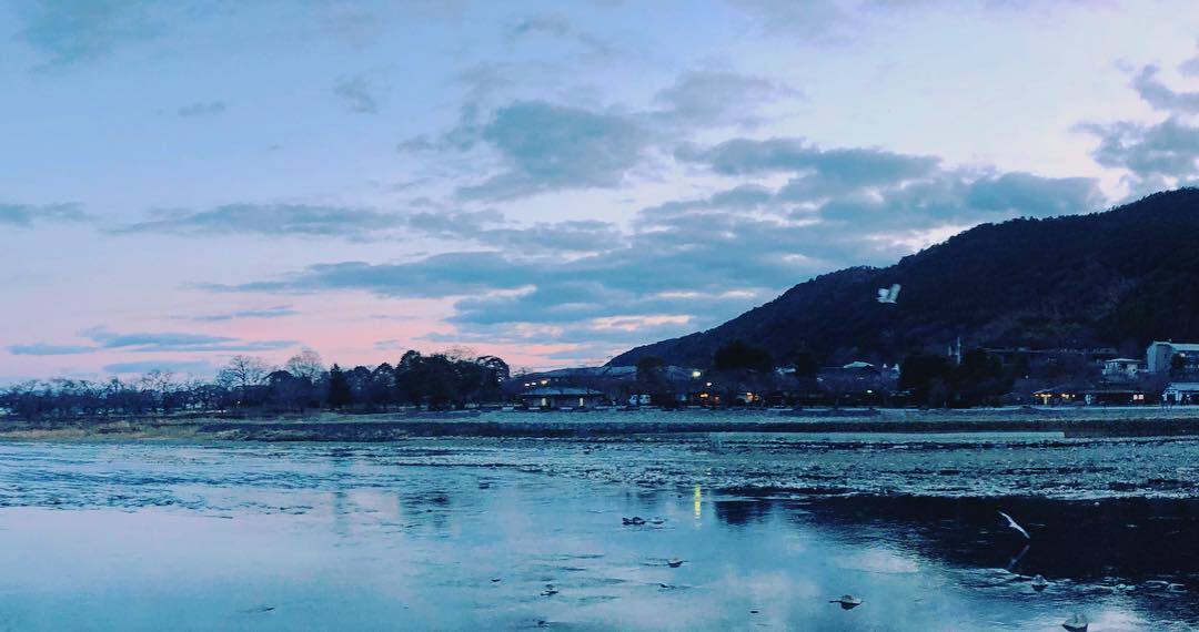 夕暮れの川と、青い山の影